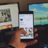 social 核验台主笔在暖色台灯下对照多台设备记录社交产品注册流程，桌面散落着写满笔记的纸张
