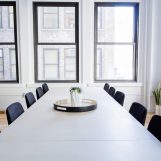 social 核验员在明亮的办公室内逐条比对社交平台隐私条款文本，屏幕上显示大段密集文字